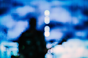 Blurred silhouette of the artist singer with a guitar on a scene. Abstract rock concert concept performance, blur background.