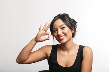 Pretty young asian woman sitting at the table