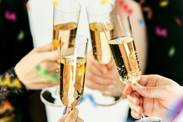 Celebration. Hands holding the glasses of champagne and wine making a toast. The party, alcohol, lifestyle, friendship, holiday, christmas, new, year and clinking concept