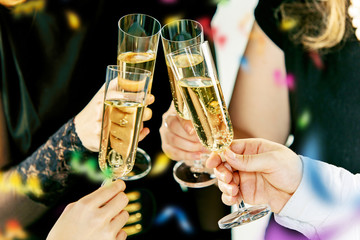 Celebration. Hands holding the glasses of champagne and wine making a toast. The party, alcohol, lifestyle, friendship, holiday, christmas, new, year and clinking concept