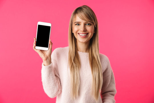 Cheerful young blonde woman wearing sweater