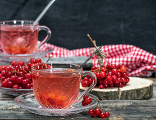 hot viburnum tea in a transparent cup with a handle