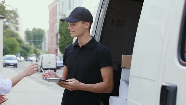 Delivery Courier Service. Man Delivering Package To Woman