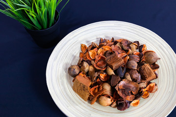Potpourri Close-up view in the wooden plate with dark background