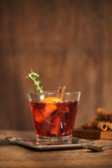 Autumnal concept with cup of tea with lemon, cinnamon stick and anise star on rustic wooden background