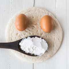 eggs and powder on white wooden background,