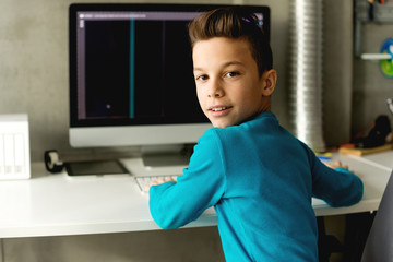 Smiling boy in front of computer © Stock Rocket