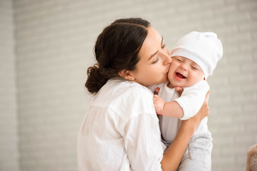 Happy loving family. Mother and her son child boy playing and hu