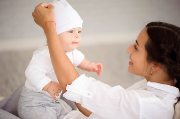 Fototapeta premium Happy loving family. Mother and her son child boy playing and hu