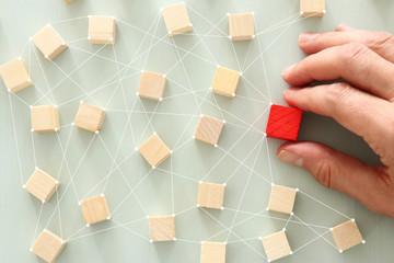 image of wooden blocks over mint table,building a strong team, human resources and management...