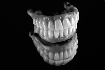 set of dentures on the upper and lower jaw, filmed in black and white style
