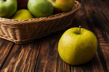 golden delicious apple with fruit wicker basket at background