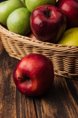 red delicious apple with fruit wicker basket at background