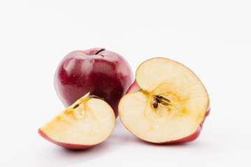 cut and whole tasty ripe apples on white background