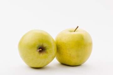 ripe golden delicious apples on white background