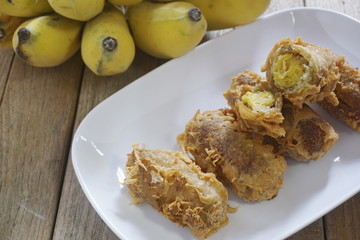 Deep fried unripe rice and grated Coconut Bananas Roll