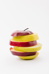 Fototapeta na wymiar tasty sliced red and golden apples on white background