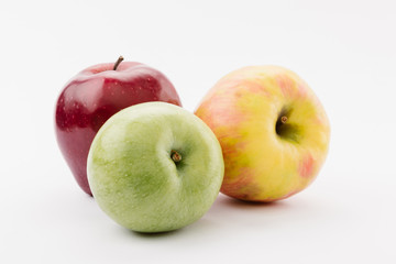 fresh red, green and yellow apples on white background