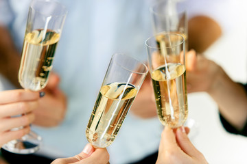 Celebration. Hands holding the glasses of champagne and wine making a toast. The party, alcohol, lifestyle, friendship, holiday, christmas, new, year and clinking concept