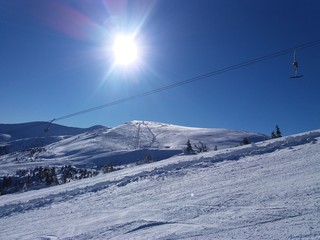 Sunrise in the snowy mountains. Carpathian mountains in the snow. Cable car.