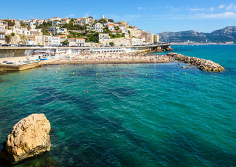 General view of the Prophet beach in Marseille, France, a very popular family beach located on the Kennedy corniche, on a hot and sunny spring day. - obrazy, fototapety, plakaty