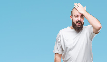 Young caucasian hipster man wearing casual t-shirt over isolated background surprised with hand on head for mistake, remember error. Forgot, bad memory concept.