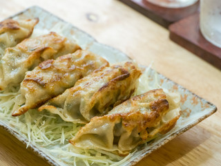 gyoza in dish on wooden table background,