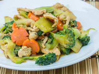 Sautéed mixed vegetables in oyster sauce on wooden background,