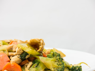 Sautéed mixed vegetables in oyster sauce on white background,