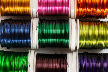 Some  spools of colored metallic thread