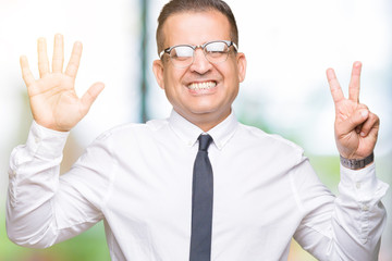 Middle age bussines arab man wearing glasses over isolated background showing and pointing up with fingers number seven while smiling confident and happy.