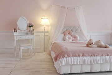 bed in bedroom with pink walls and white wooden floor and mirror in the luxury apartment