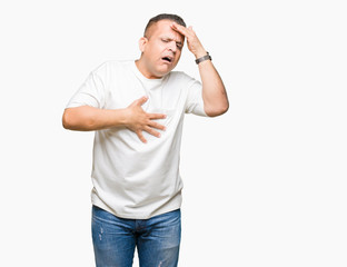 Middle age arab man wearig white t-shirt over isolated background Touching forehead for illness and fever, flu and cold, virus sick