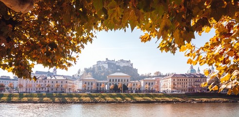Wide autumn cityscape panorama of Salzburg, Austria. Castle in the background