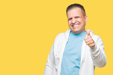 Middle age arab man wearing sweatshirt over isolated background doing happy thumbs up gesture with hand. Approving expression looking at the camera showing success.