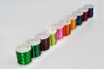 Some  spools of colored metallic thread