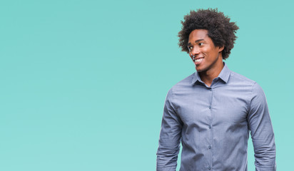 Obraz premium Afro american man over isolated background looking away to side with smile on face, natural expression. Laughing confident.