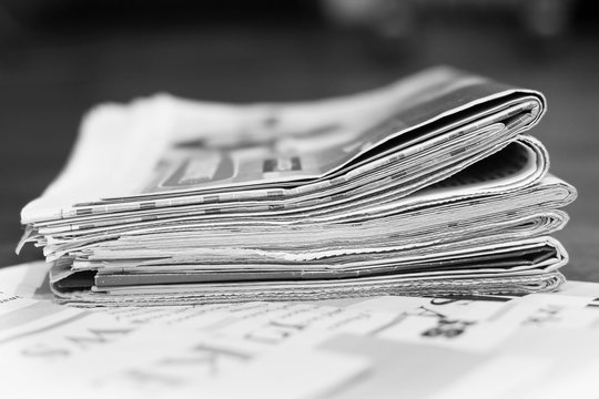 Stack of newspapers and magazines, Business journals with headlines and articles stacked in heap. Tabloid papers                               with latest news