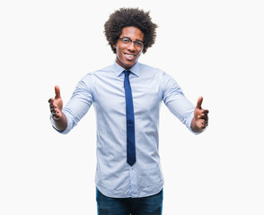 Afro american business man wearing glasses over isolated background looking at the camera smiling with open arms for hug. Cheerful expression embracing happiness.