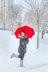 Young girl playing with snow in the park
