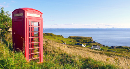 Lonely red phone booth in the countryside at Isle of Skye, Scotland, UK