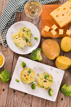 Potato gratins with broccoli florets.