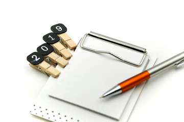 Text 2019 goals on notebook with pen on white background,New year Concept