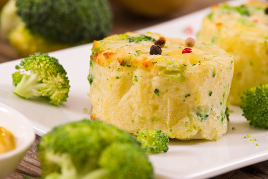 Potato gratins with broccoli florets.