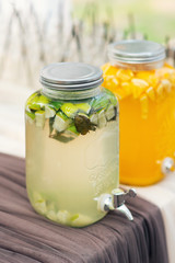Glass jars of lemonade on wedding candy bar. Catering. Drinks on wedding party