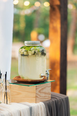 Glass jars of lemonade on wedding candy bar. Catering. Drinks on wedding party