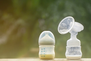 The breast pump every 2 hour. Mother's breast milk is the most healthy food for newborn baby. The image of parenting. Concept with feeding bottle of baby milk formula on stock freeze for healthy child