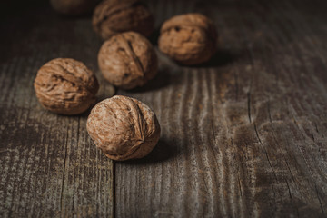 close up view of walnuts on wooden backdrop