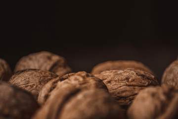 close up view of walnuts on black backdrop
