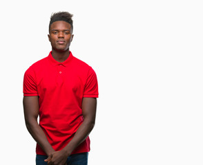 Fototapeta premium Young african american man over isolated background with serious expression on face. Simple and natural looking at the camera.
